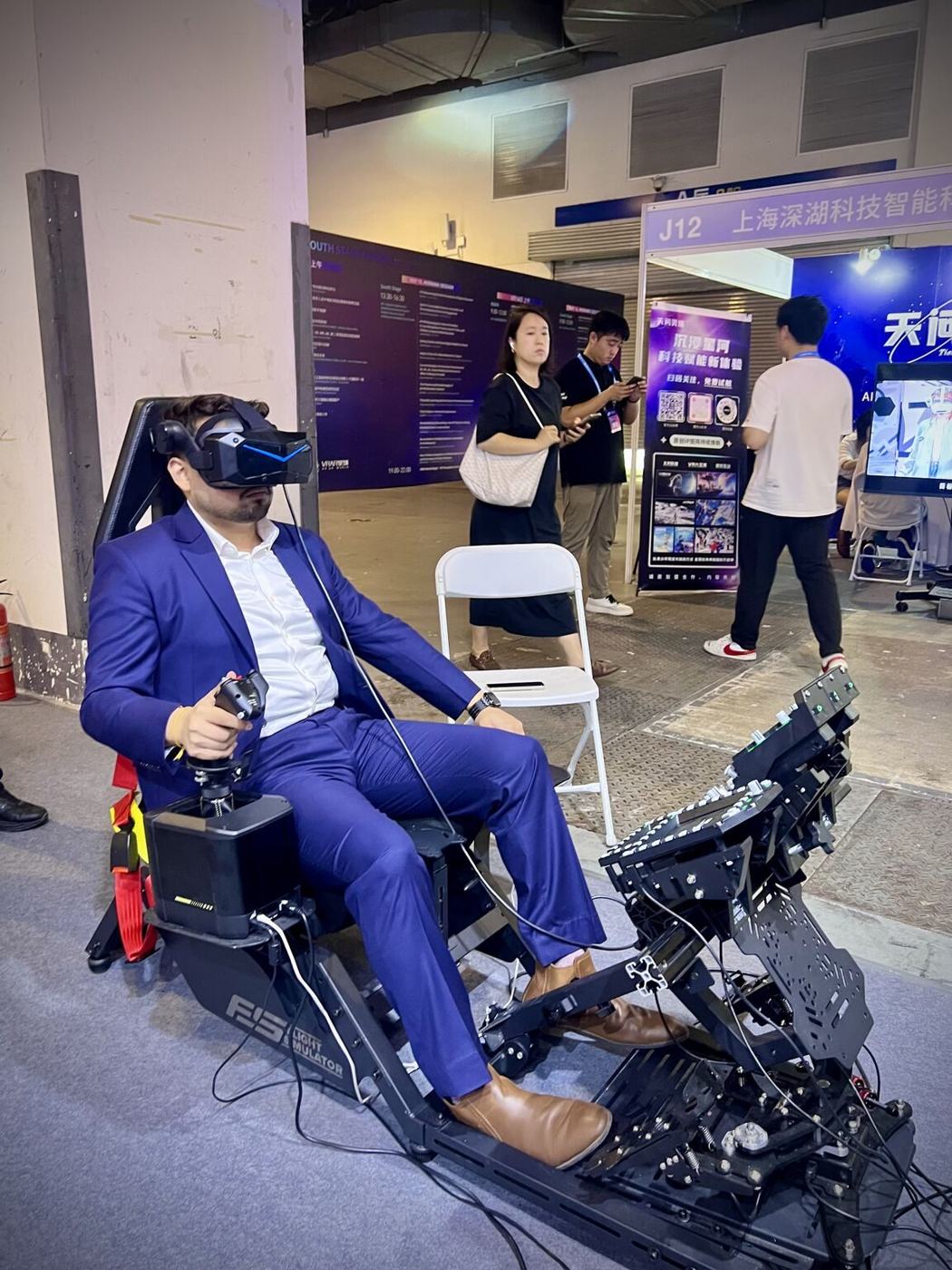 Sanan Goyal trying a VR motion simulator at VRAR Expo China 2025